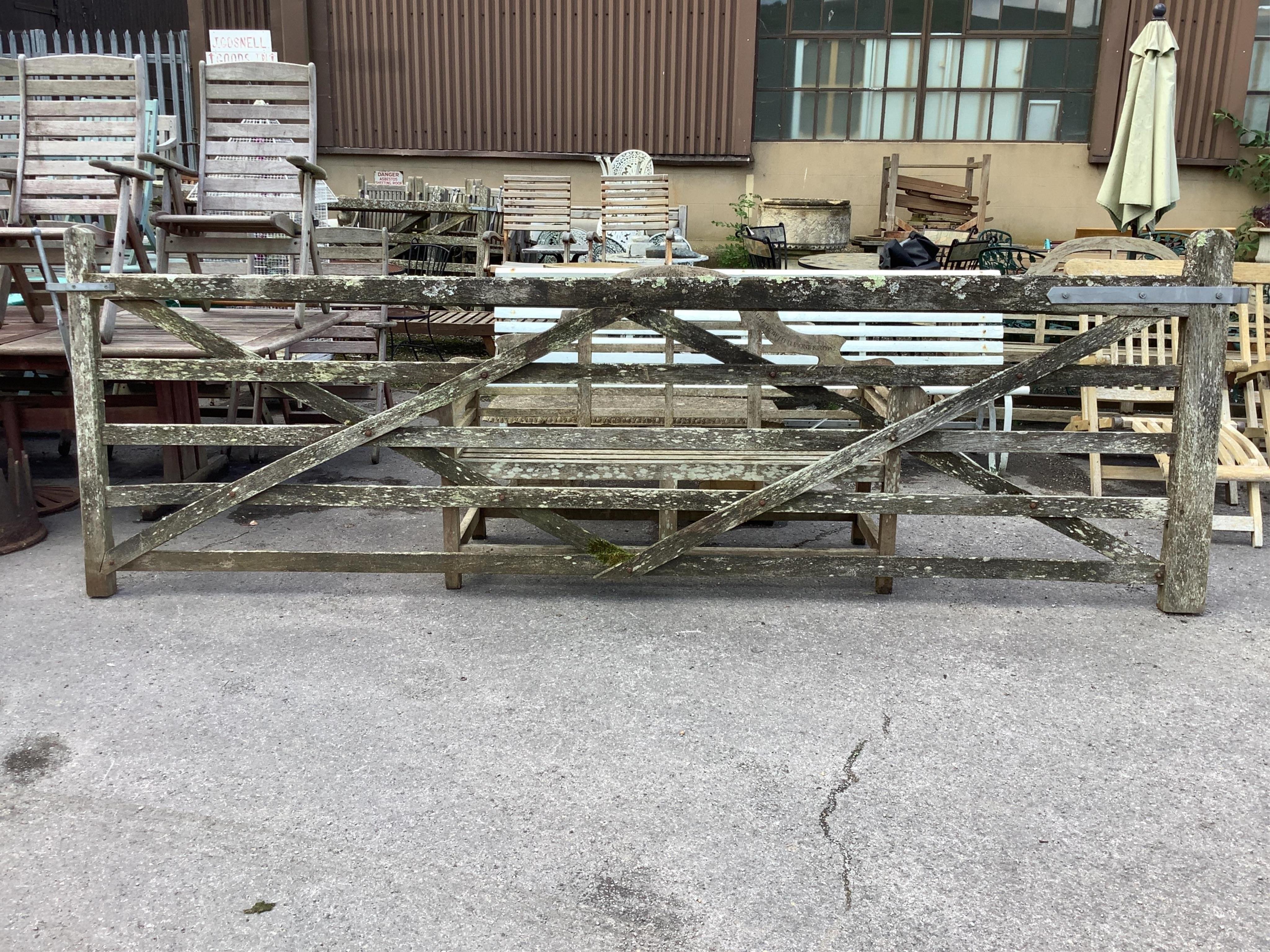 A pair of 12ft Biddenden hardwood gates with galvanised mounts. Condition - poor to fair